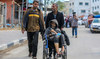 People flee the eastern parts of Rafah after the Israeli military began evacuating Palestinian civilians.