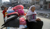 Displaced Palestinians, who fled Jabalia after the Israeli military called on residents to evacuate, travel in a cart.