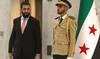 Syria’s President Ahmed Al-Sharaa (L) arrives to receive UN Secretary-General Antonio Guterres at the People’s Palace.