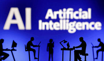 Figurines with computers and smartphones are seen in front of the words "Artificial Intelligence AI". (REUTERS)