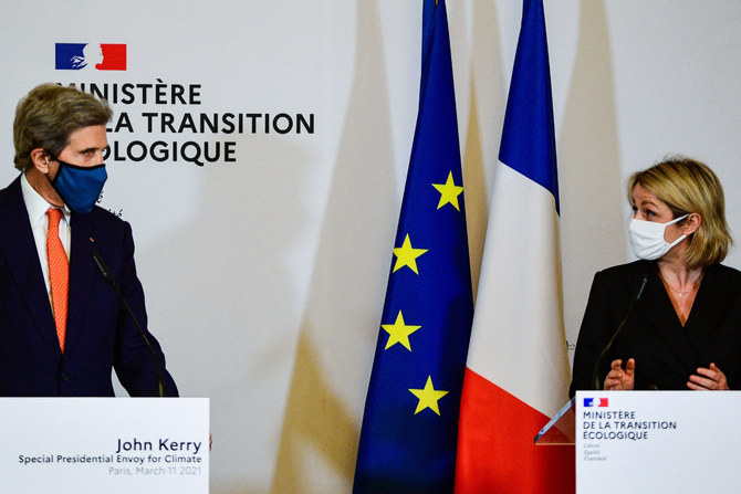 French Ecological Transition Minister Barbara Pompili (R) and US climate envoy John Kerry (R) speak during a press conference in Paris, on March 11, 2021. (AFP / Martin Bureau)