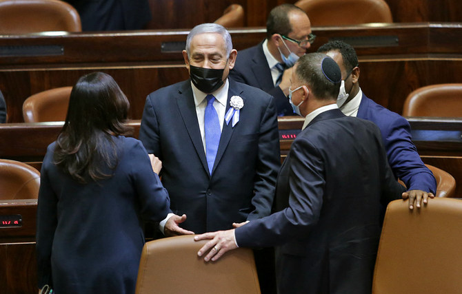 Israeli Prime Minister Benjamin Netanyahu (C) leaves after the swearing-in ceremony of Israel's Knesset (parliament) in Jerusalem on April 6, 2021. (AFP / POOL / Alex Kolomoisky)