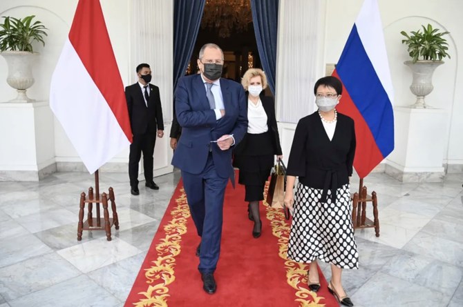 Russian Foreign Minister Sergei Lavrov, center, walks with Indonesian FM Marsudi, right, after their meeting in Jakarta on July 6, 2021. (Indonesian Ministry of Foreign Affairs via AP)
