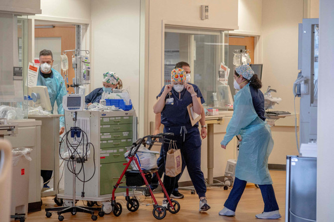 Healthcare workers are seen inside the CNorth Oaks Hospital in Hammond, Louisiana, on August 13, 2021 as Louisiana Governor John Bel Edwards ordered an indoor mask mandate amid COVID-19 surge. (Photo by Emily Kask / AFP)
