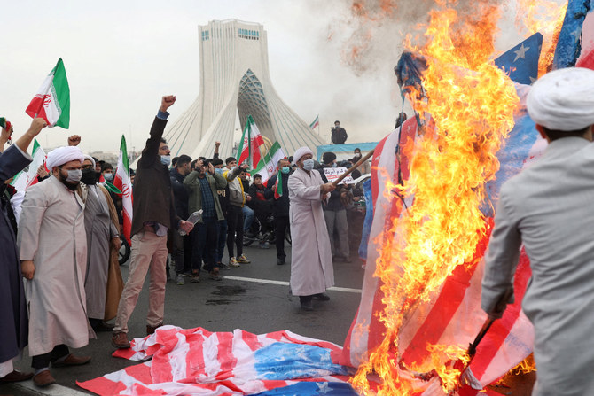 Iranian clerics set fire to the American flag in Tehran on Feb. 11, 2022, as they marked the anniversary of Iran's 1979 revolution. (Majid Asgaripour/WANA via REUTERS)