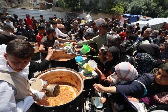 Using the starvation of civilians as a method of warfare is classified as a war crime under international law (File/AFP)