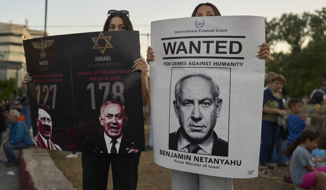 Protesters hold placards depicting Israeli PM Benjamin Netanyahu during a demonstration in Athens, May 22, 2025. (AP)