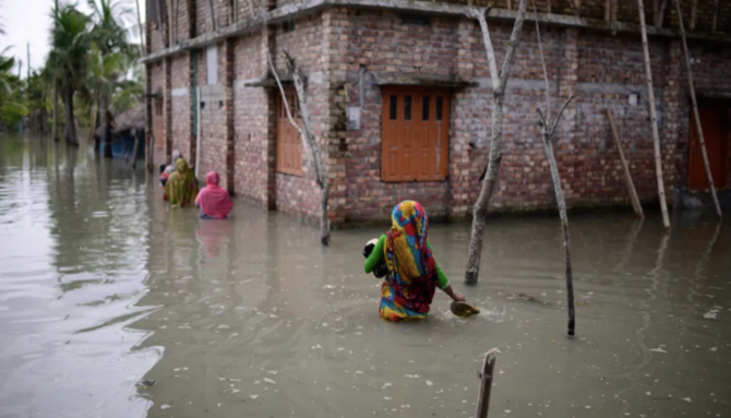 Villagers wade through waist-deep waters to reach their homes in Bangladesh. (AP/File Photo)