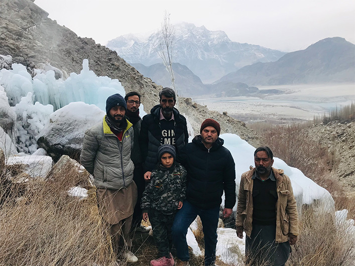 Residents of Hussainabad Valley of Skardu district in Gilgit-Baltistan, Pakistan, pose for a photograph in front of an ice stupa on December 26, 2012. (AN Photo by Nisar Ali). 
